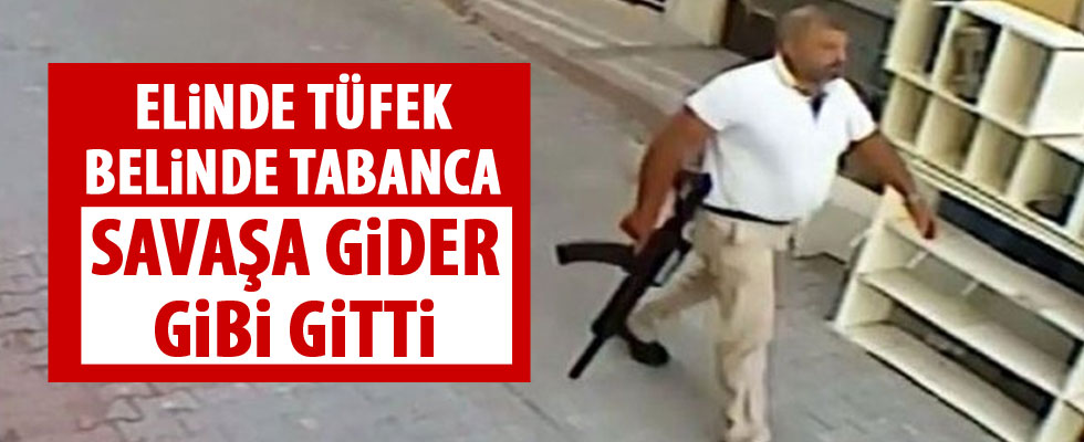 Elinde tüfek, belinde tabanca ile gitmiş