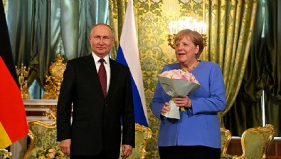 Rus lider Putin Merkel’le görüşmesine çiçekle geldi!